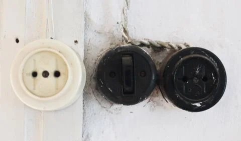Two sockets and a switch on the wall in a rural house Foto stock