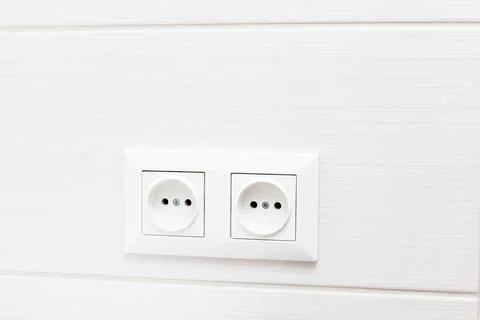 Two sockets on the white tile wall. bathroom interior Stock-Fotos