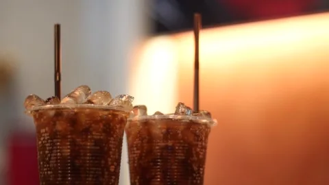 Two Sodas with Ice and Straws in Plastic Cups Stock Footage 246715636