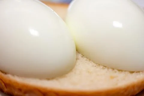 Two soft boiled eggs served on a slice of fresh toasted bread for breakfast Stock Photos