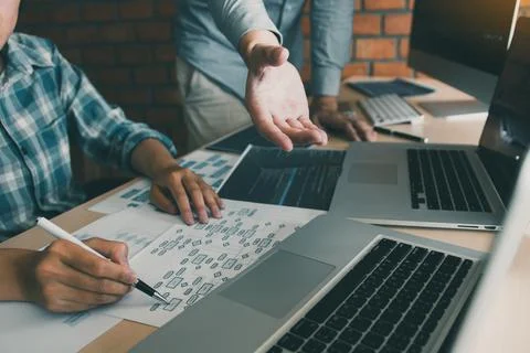 Two software developers are analyzing together about the code written into .. 库存照片