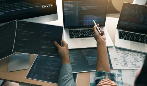 Two software developers are using computers to work together with their par.. Foto stock