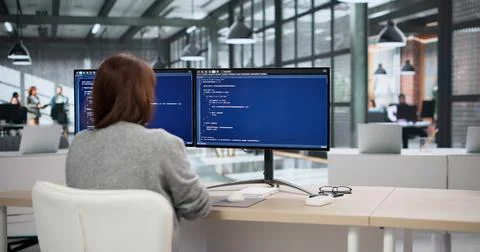 Two Software Developers Coding On Computers While An Accountant Reviews Billi Stock Photos
