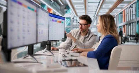 Two Software Developers Collaborate On CRM Functionality In Corporate Meeting Stock Photos