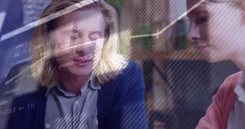 Two software developers collaborating in modern office, with animated code Stock Footage 307447799