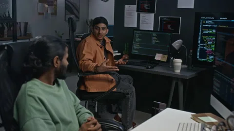 Two Software Developers Discussing Code in Tech Office Stockbeeldmateriaal 348371745