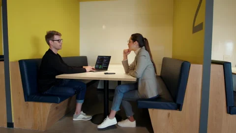Two software developers having a discussion in a coworking office Stock Footage 221177932