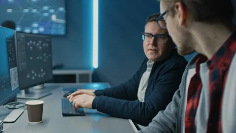 Two Software Developers Programming, Talking and Finding Solutions while Working Stock Footage 103270600