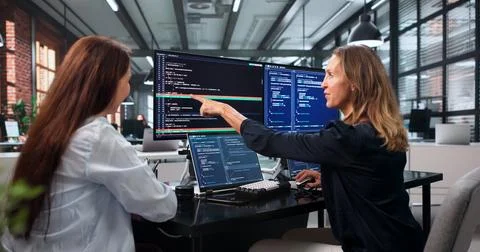 Two Software Developers Work Together On Solving Code Conflicts Using Visual  Fotos Stock