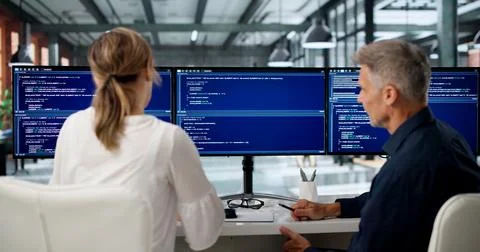 Two Software Engineers Discuss Coding Ideas While Working Together. Stock Photos