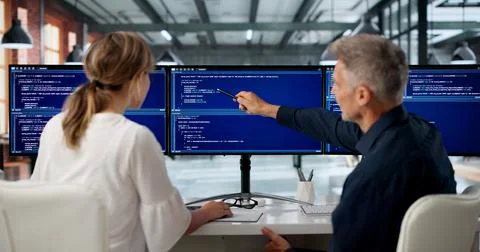 Two Software Engineers Work Side By Side Coding Secure Web Applications Toget Stock Photos