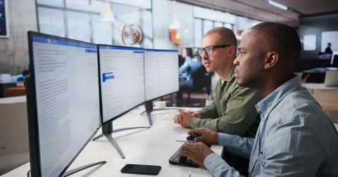 Two Software Engineers Work Together On Secure Web Application Coding. Stock Photos