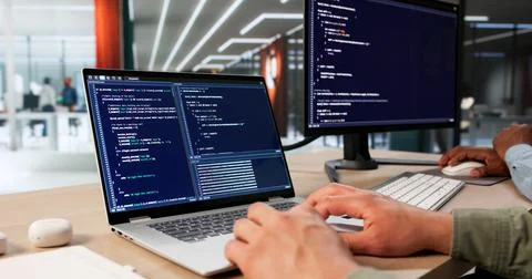 Two Software Engineers Work Together Coding Secure Data Systems At Desk. Foto stock