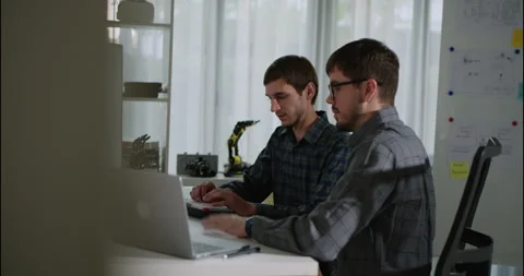 Two Software Engineers Working on Code Together at a Desk in Tech Office. Stock Footage 306738368