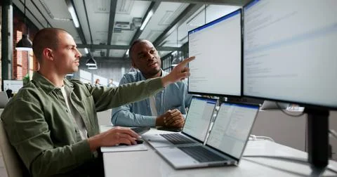 Two Software Engineers Working Together On Secure Web Application Code. Stock Photos