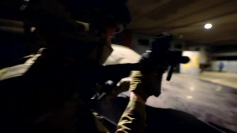 Two soldiers at a brick wall, weapons at the ready, blue and red glare. Stock Footage 301302224