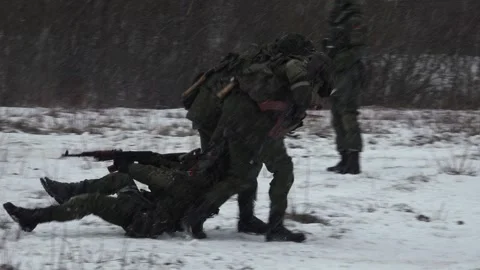 Two soldiers dragging a wounded soldier Stock Footage 266102729