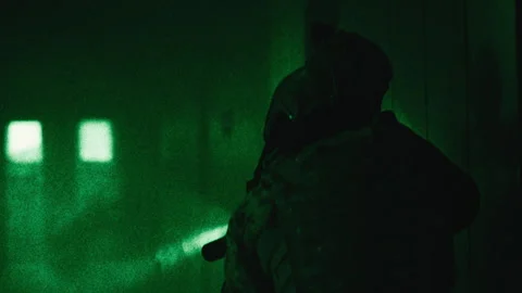 Two soldiers with guns walking down a corridor night-vision Stock Footage 275095030