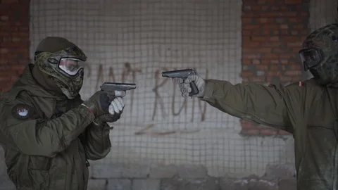 Two soldiers hold each other at gunpoint Stock Footage 101690748