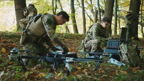 Two soldiers in military uniform using laptop computer for drone controlling in Stock-Footage 244082004