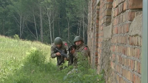 Two Soldiers Pull Security While Moving Along a Wall* 스톡 동영상 115129409