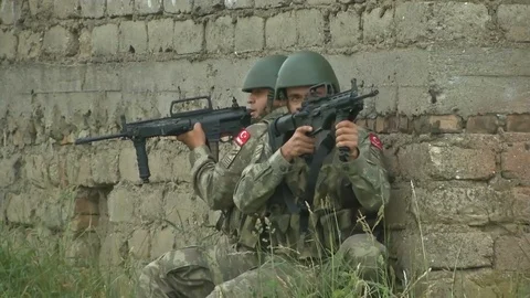 Two Soldiers Pulling Security Back to Back against a Wall* Video stock 115129301