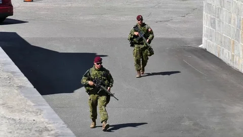 Two soldiers walking with gun Stock Footage 95266310