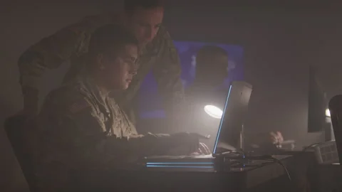 Two Soldiers Working on a Computer Stock Footage 208783115