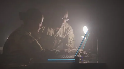 Two Soldiers Working on a Computer Together Stock Footage 208783680
