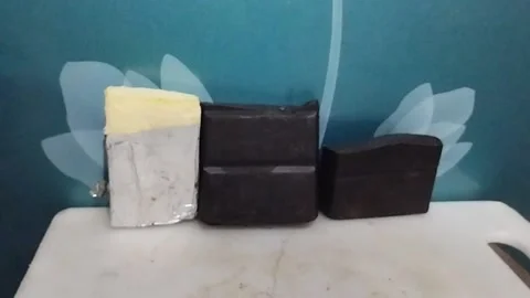 Two Solid Chocolate Bars and One Block of Cheese on the Table Stock Footage 229304348