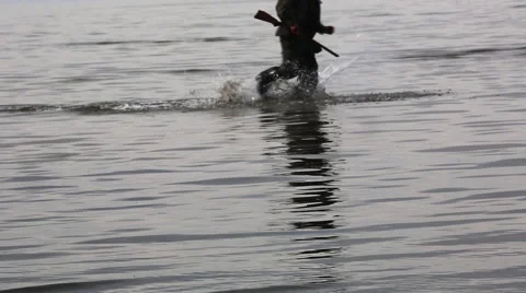 Two Soliders run through the water Stock Footage 40803967