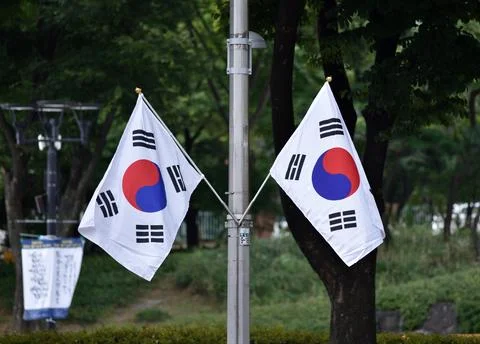 Two South Korean flags on a pole in a park setting in Seoul, South Korea Stock Photos