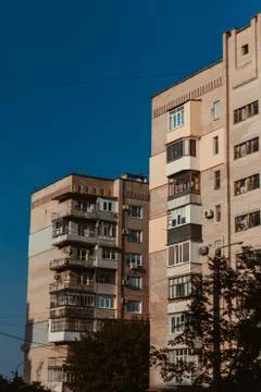 Two Soviet buildings one after another against the blue sky Stock Photos