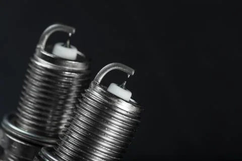Two spark plugs on black background Stock Photos