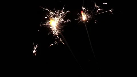 Two sparklers burning on black background isolated Stock Footage 132127831