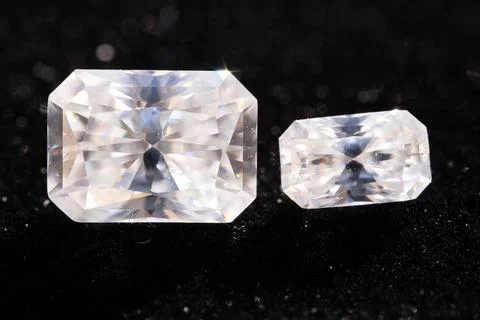 Two Sparkling Clear Emerald Cut Diamonds Displayed Side by Side on Black Ba.. Stock Photos