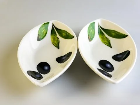 Two special ceramic containers for olives on a white background. Stock Photos
