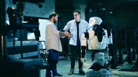 Two specialists and a robot in a laboratory Stock Footage 150795015