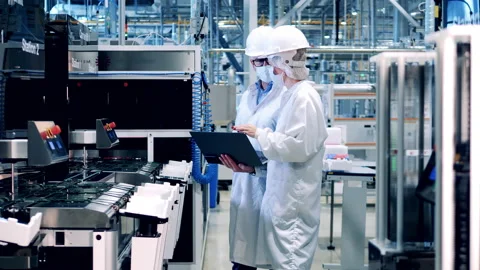 Two specialists in face masks are watching solar cell manufacturing Stock-Footage 166901872