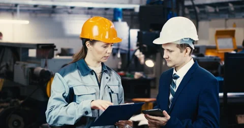Two specialists inspect the construction site of a commercial, industrial Stock Footage 167557642
