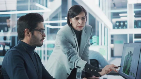 Two Specialists Working on Computer in Office Stock Footage 224519241