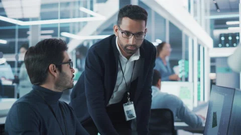 Two Specialists Working on Computer in Office Stock Footage 224519283