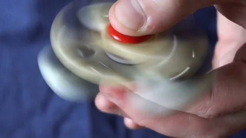 Two spinner spinning in the hand of a young man Stock Footage 76784430
