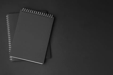 Two spiral notepads on a black background Stock-Fotos