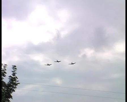 Two Spitfires and a Hurricane fly overhead in formation, with audio - DV PAL 動画素材 1044014