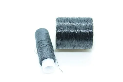 Two spools of black thread located on a white background Stock Photos