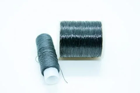 Two spools of black thread located on a white background Stock Photos