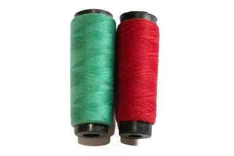 Two spools of colored thread side by side green thread Stock Photos