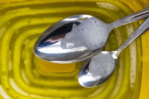 Two Spoons in the Phase of Washing Stock Photos