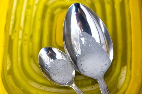 Two Spoons in the Phase of Washing Stock Photos